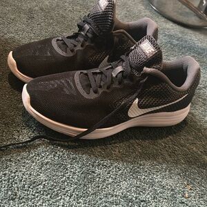 Black Nike running sneakers. Worn only a handful of times. Great condition.